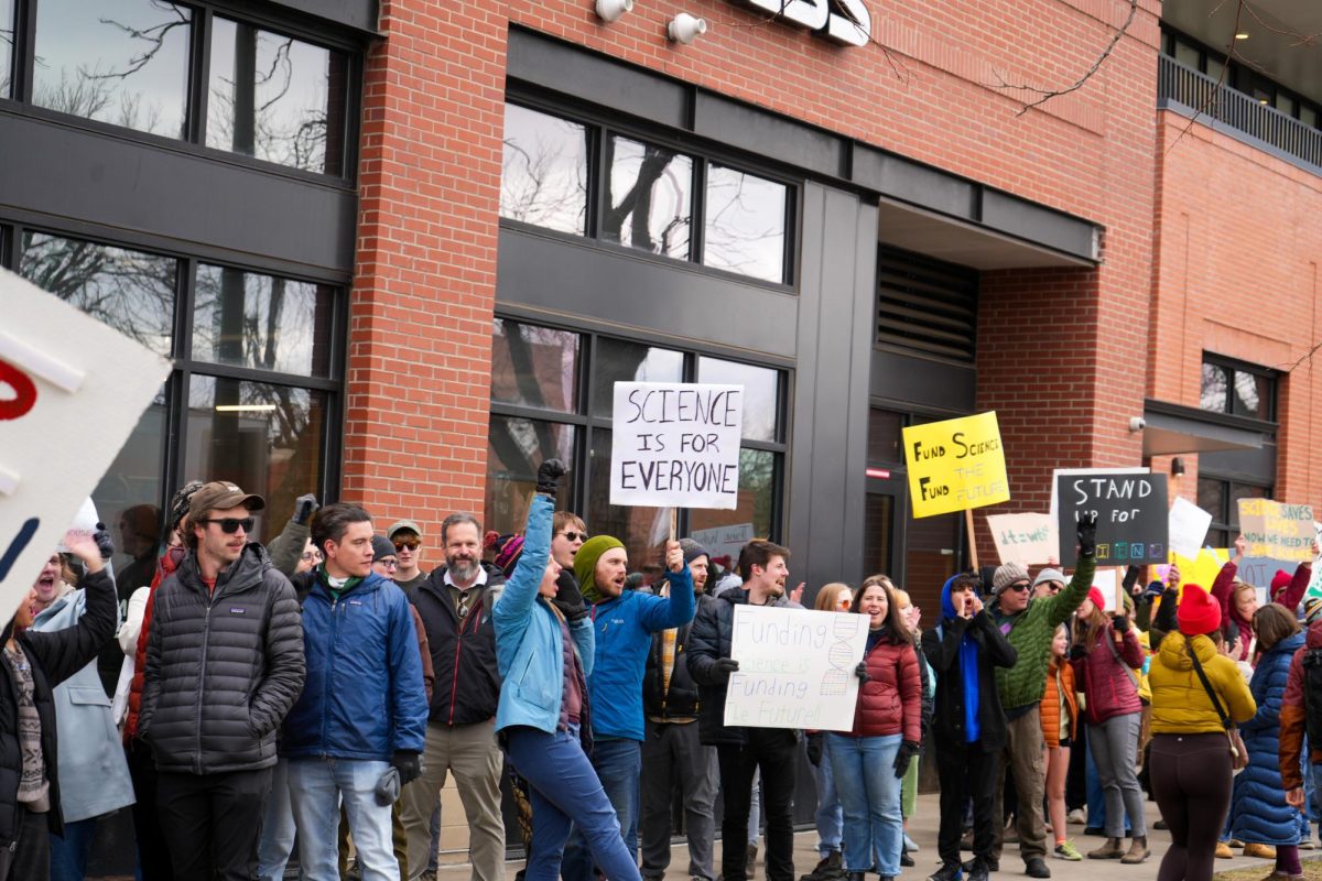 CSU students, faculty, and community members make their way to Old Town Square on N. College Avenue, cheering as cars honk in support as the drive by. 