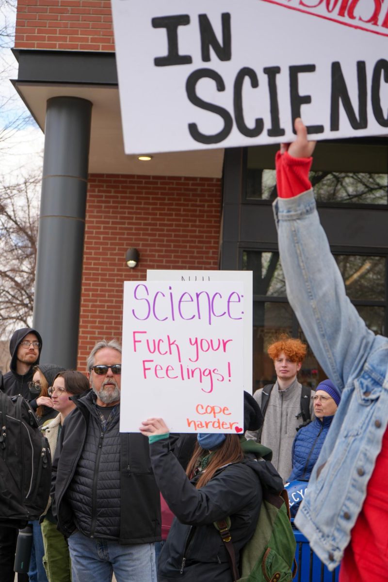 Protesters hold signs on their way up College Avenue toward Old Town Square in support of the nationwide Stand Up for Science protest March 7. 