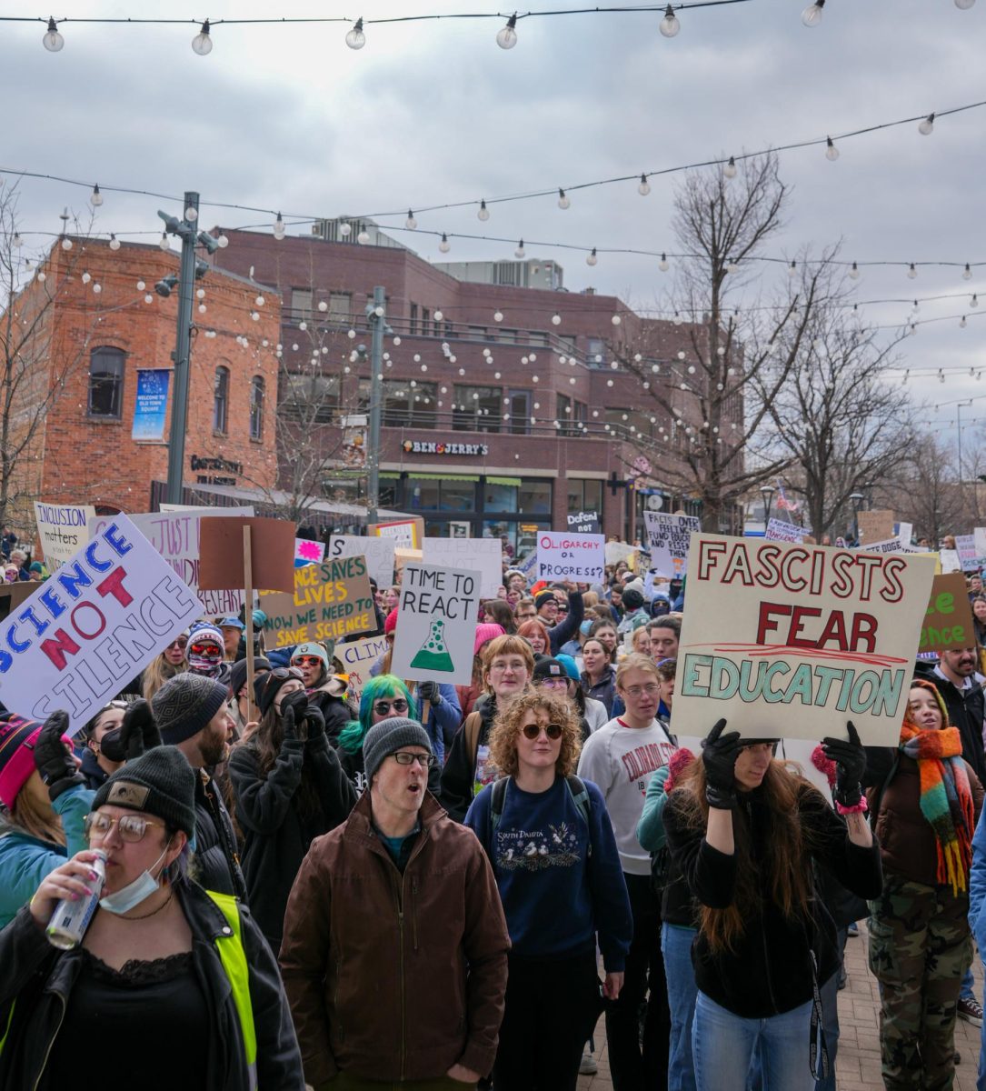 Demonstrators gather in Old Town Square in support of the nationwide Stand Up for Science protest March 7. Protestors held various political signs, such as "Fascists Fear Education," "Science Not Silence" and "Time To React."