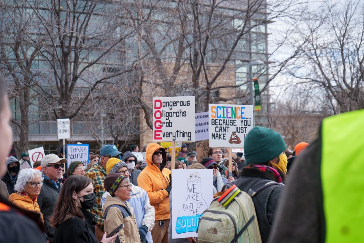 CSU students, faculty, and community members gather with homemade signs, many protesting the new Department of Government Efficiency (DOGE) and billionaire Elon Musk's efforts to reduce federal spending that affect scientific research and operations. 