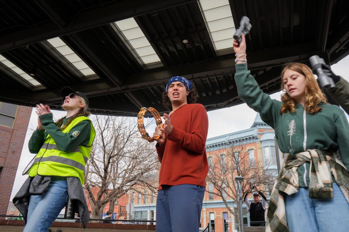 Protest leaders use tambourines and shakers to lead fun chants in Old Town Square in support of the nationwide protest "Stand up for Science" on March 7 2025. 