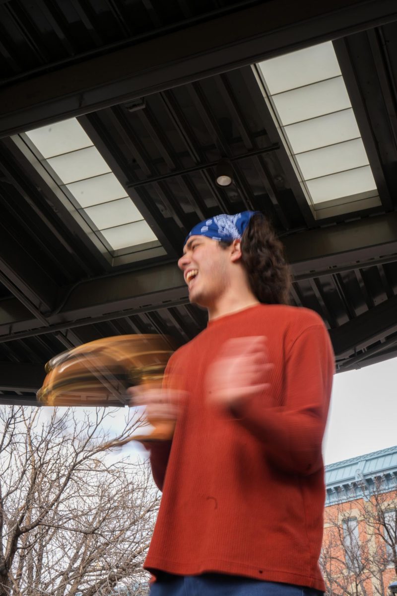 Nico Diarte, student at Colorado State University, leads a chant with the help of a tambourine at the "Stand up for Science" demonstration in Old Town Square on March 7 2025. 