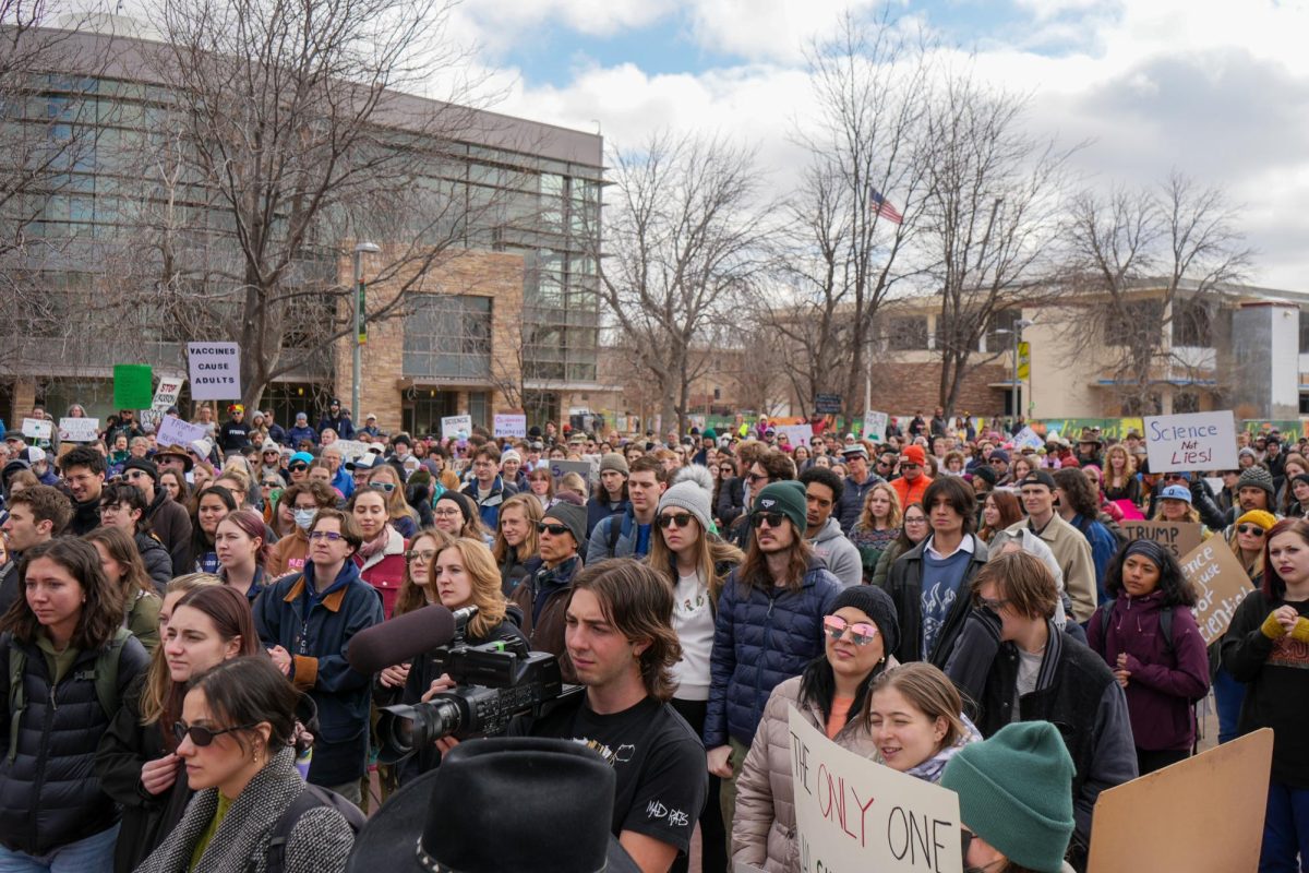 CSU students, faculty, and community members show off homemade signs and listen intently to student speakers. Despite the cold weather, the plaza was packed with protesters supporting the nationwide "Stand up for Science" protest. 