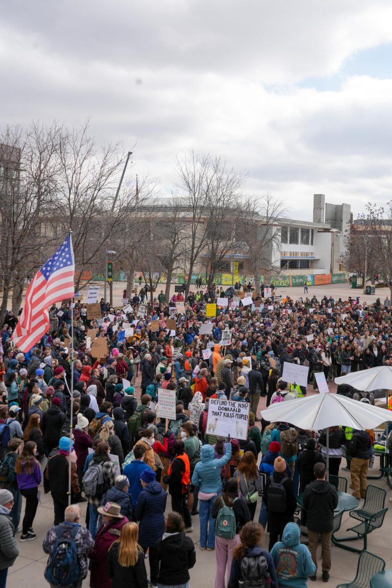 An American flag flies over CSU students, faculty, and community members who gather at the Lory Student Center plaza for the nationwide protest "Stand up for Science" on March 7, 2025. 