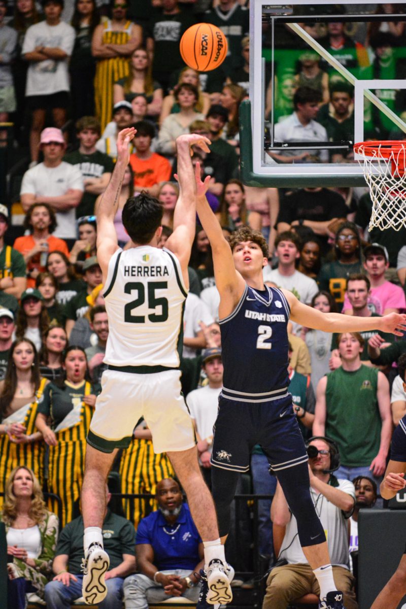 Ethan Morton shooting  a three for his team against Utah State March 1. Colorado State University defeated Utah State with a score of 93-66.