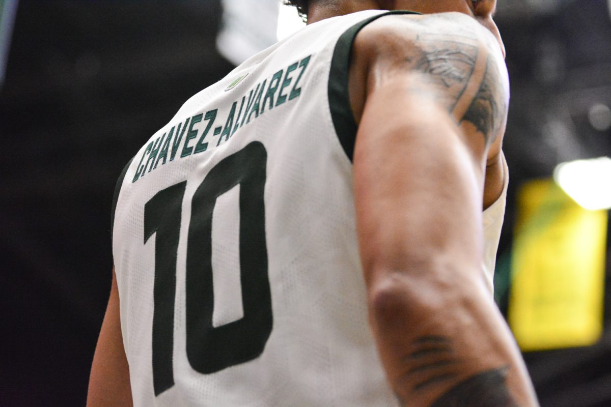 Nique Clifford about to throw the ball back into play March 1. Nique and his teammates defeated Utah State with a score of 93-66.