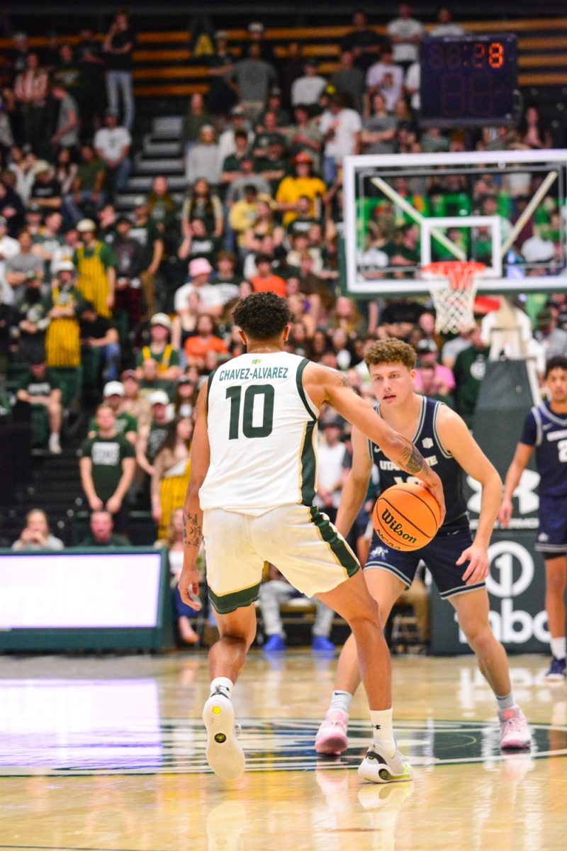 Nique Clifford dribbling the ball down the court to make a play March 1. Nique and his teammates defeated Utah State with a score of 93-66.