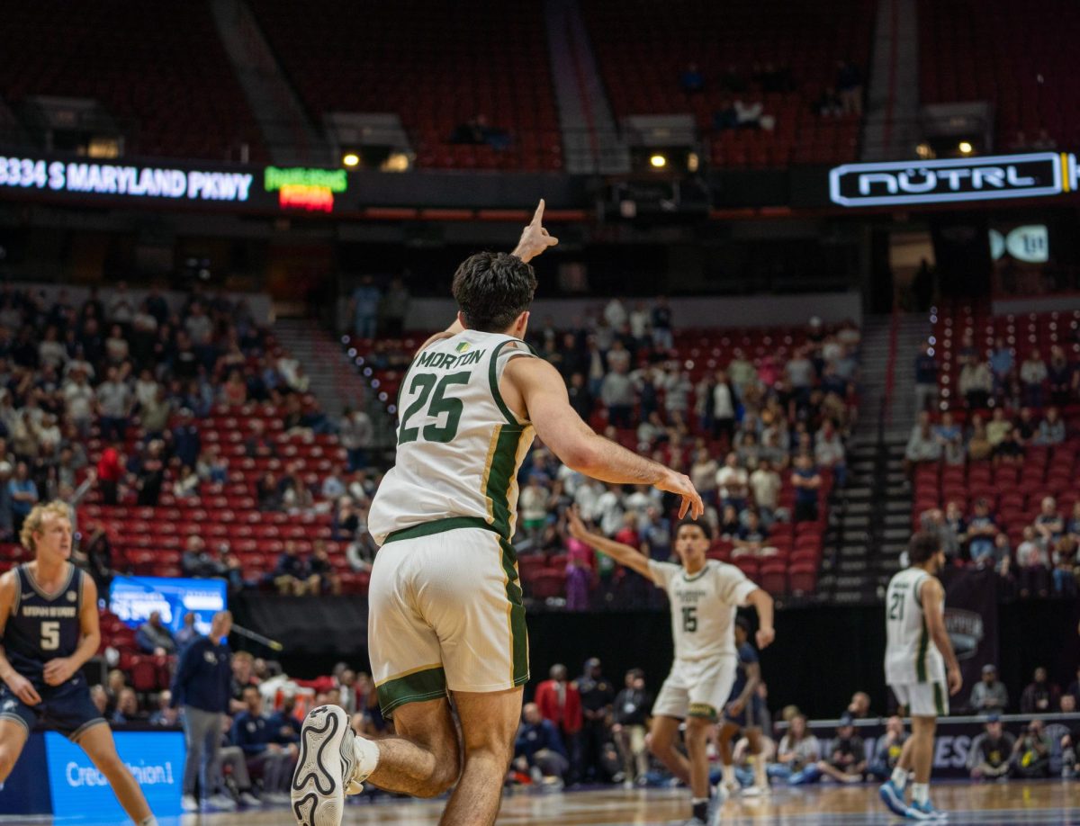 Kyan Evans (0) motions upwards in Colorado State University's MW semifinals game against Utah State Friday. CSU won 83-72 and advanced to the championship round.