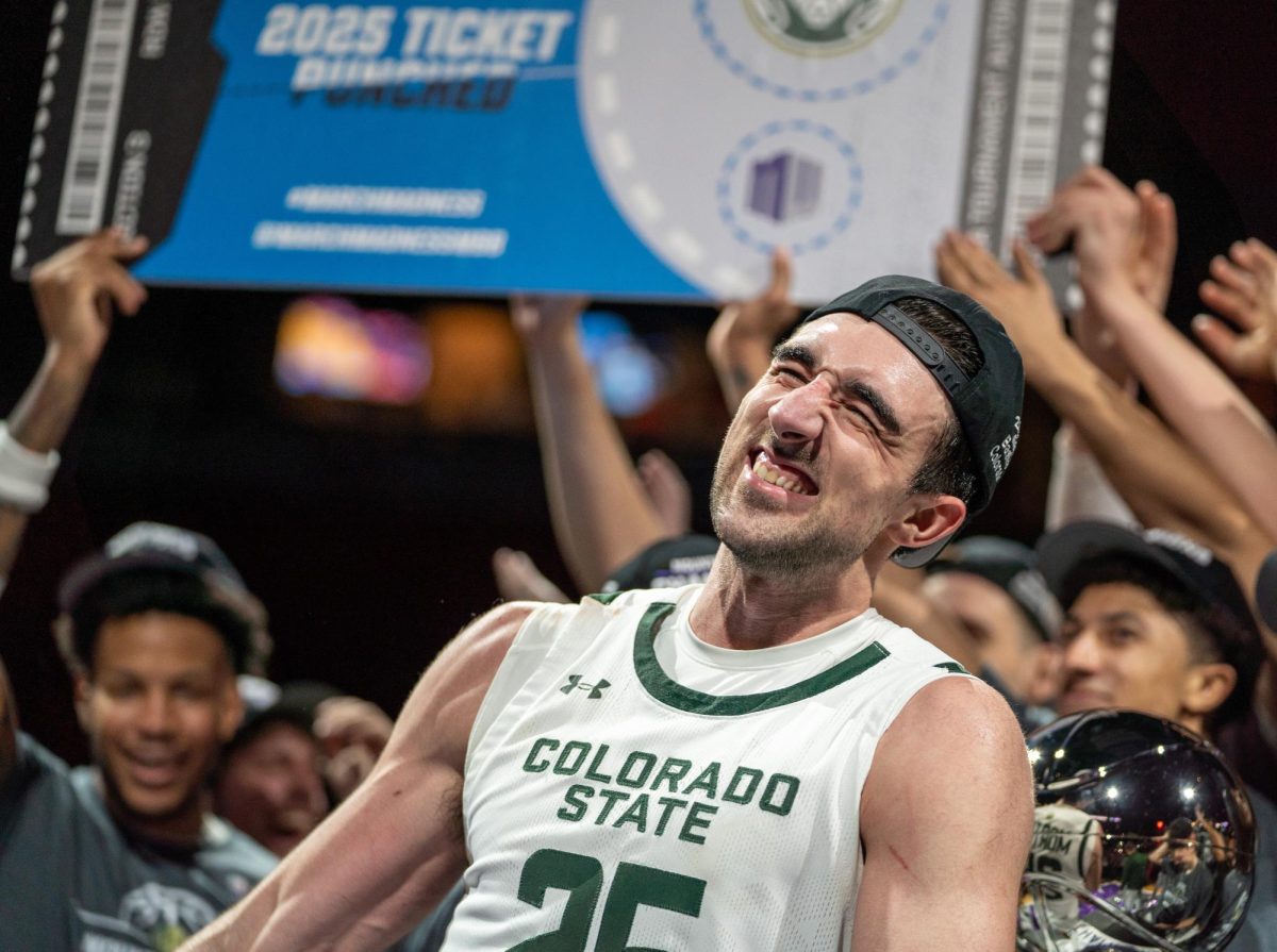 Ethan Morton (25) celebrates with the Colorado State University men's basketball team as they claim victory over Boise State in the Mountain West championship game March 15. CSU won 69-56.