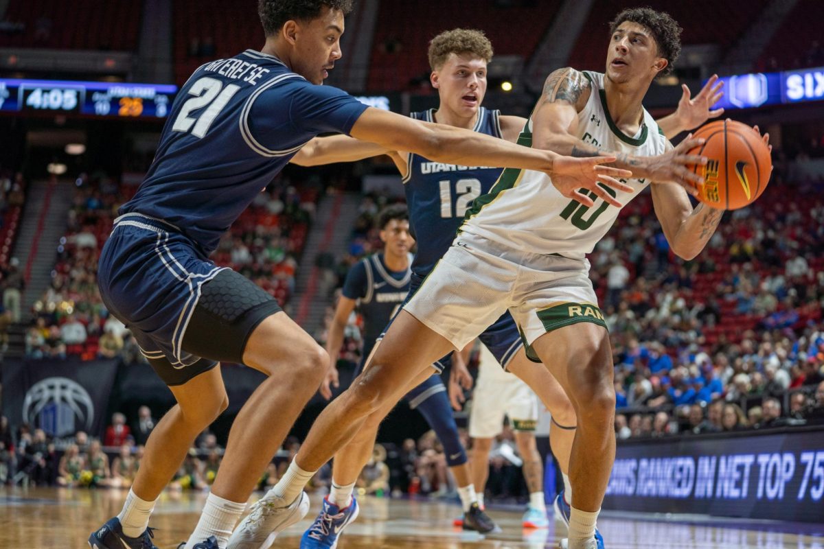 Nique Clifford (10) keeps the ball away from defenders in Colorado State University's MW semifinals game against Utah State. CSU won 83-72.