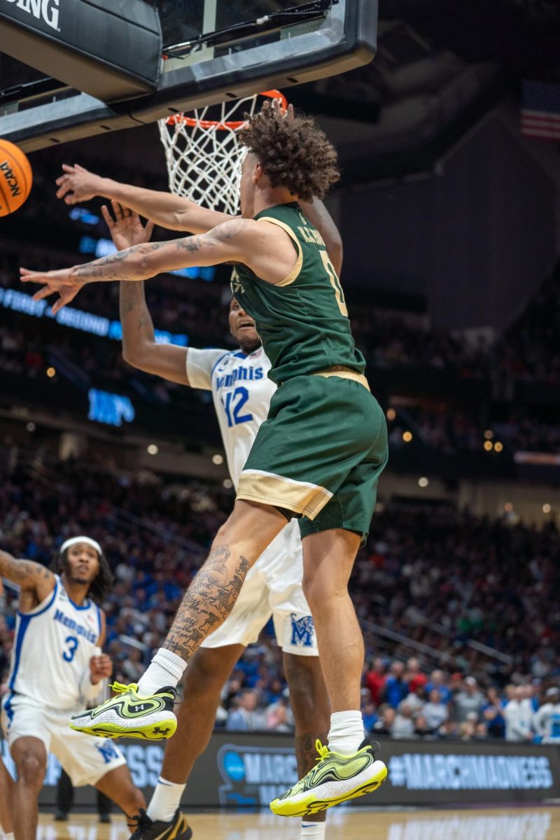 Kyan Evans (0) kicks the ball to the perimeter in Colorado State University's NCAA first-round matchup against Memphis March 21. CSU won 78-70.