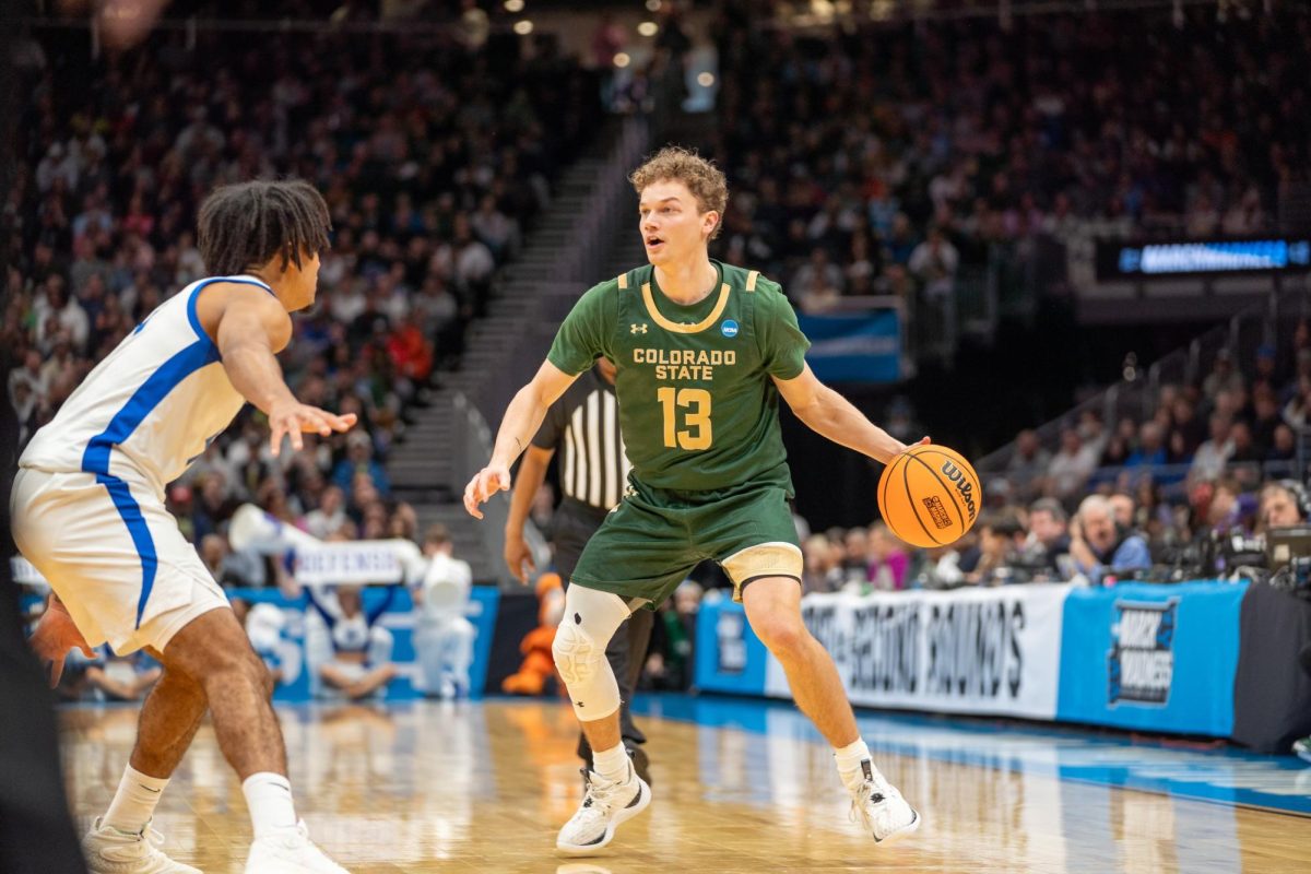Guard Bowen Born (13) looks for a teammate to pass to during Colorado State University's game against the University of Memphis in the Climate Pledge Arena in Seattle March 21. CSU won 78-70.