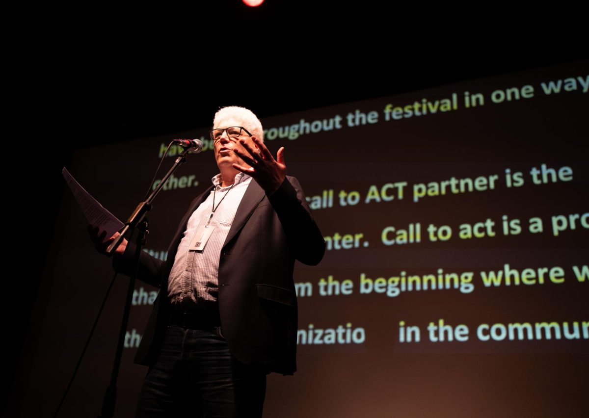 Greg Dickinson, Director of the Blake Center for Engaged Humanities at Colorado State University, addresses the crowd Friday night at the ACT Human Rights Film Festival held at the Lyric Cinema. "The festival doesn't happen without the university," Dickinson said. "You all know the universities are under attack right now and there are states where we couldn't do this." 