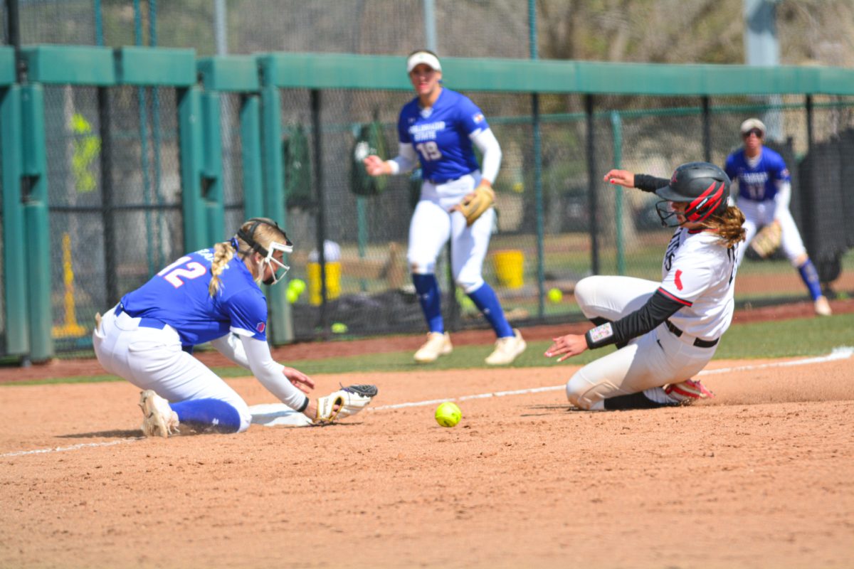 Reagan Wick attempting to catch the ball and get a San Diego State player out April 5. She was unable to get the player out however Colorado State University was able to defeat San Diego State with a score of 2-0.