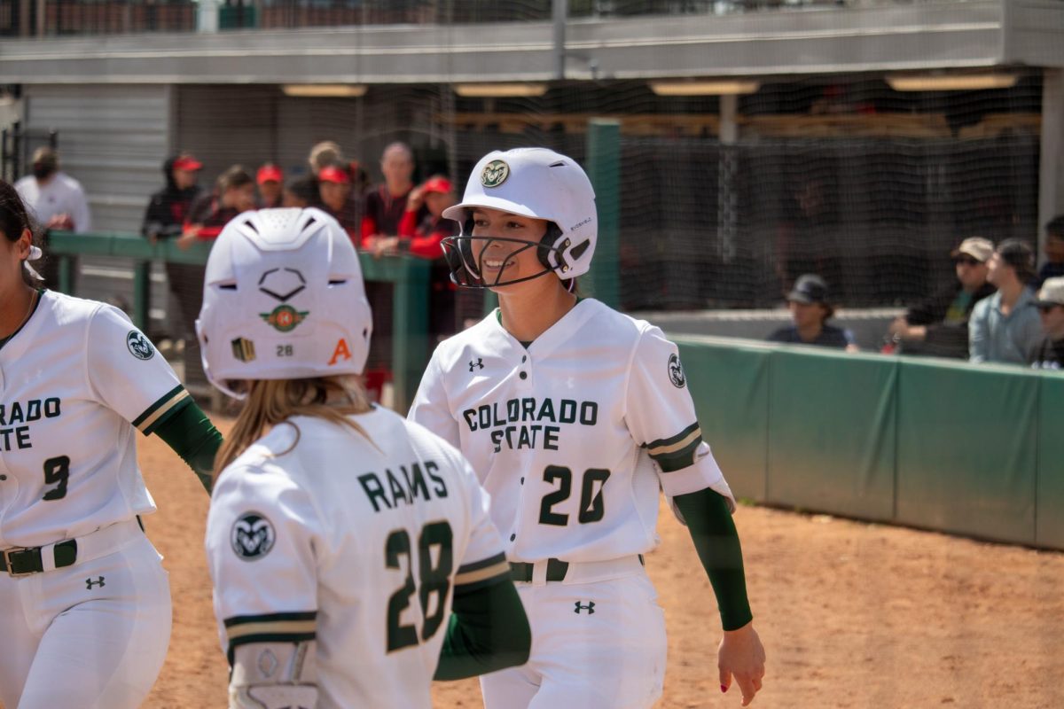 Jordan West (20) is congratulated by her teammates after hitting a home run to earn two runs during the match against San Diego State University April 6.