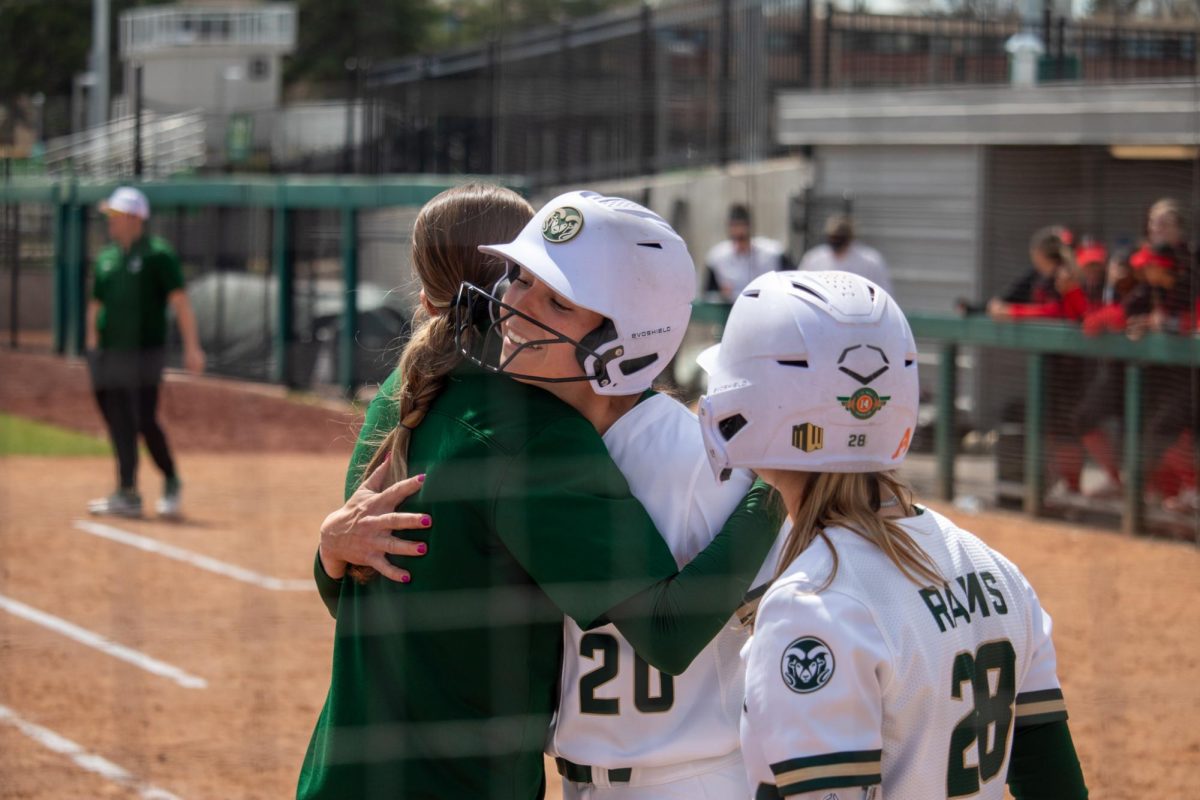 Jordan West (20) hugs a member of the Colorado State Softball team after hitting a home run during the match against San Diego State University April 6.