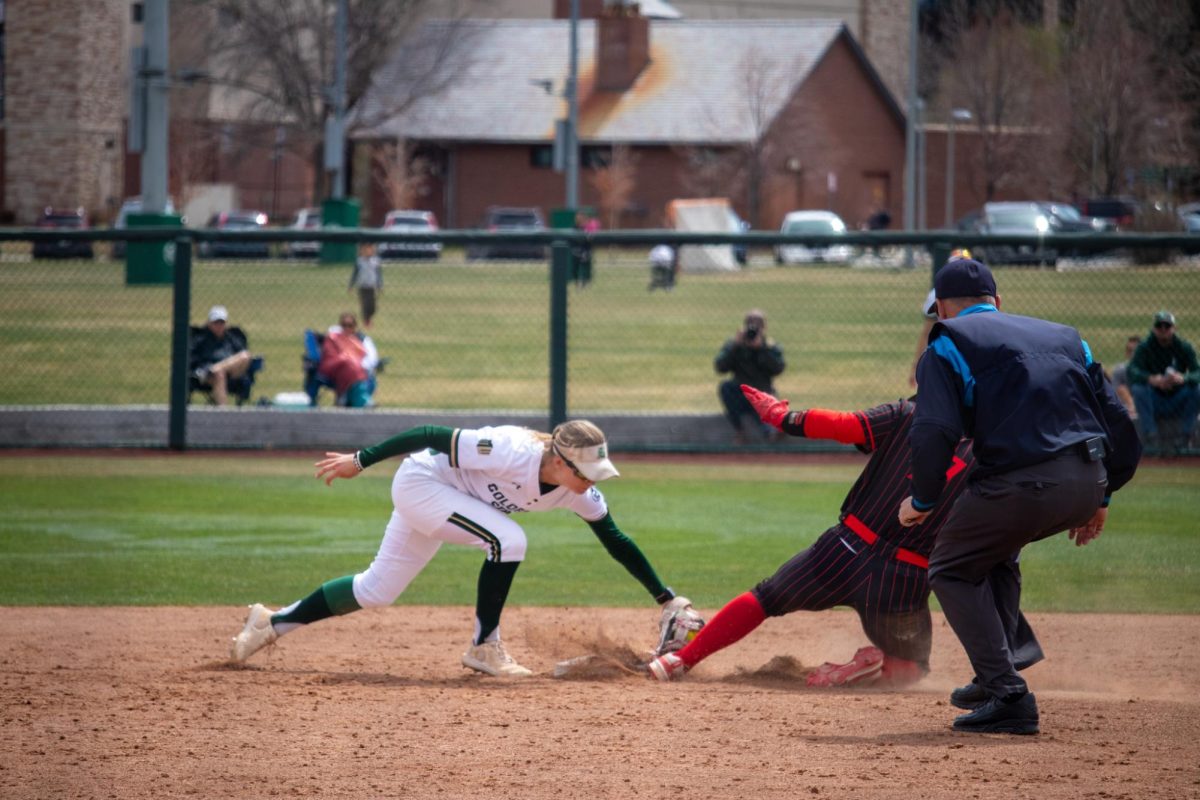Kaylynn English (28) tries to tag a player out at second base during the match against San Diego State University April 6.