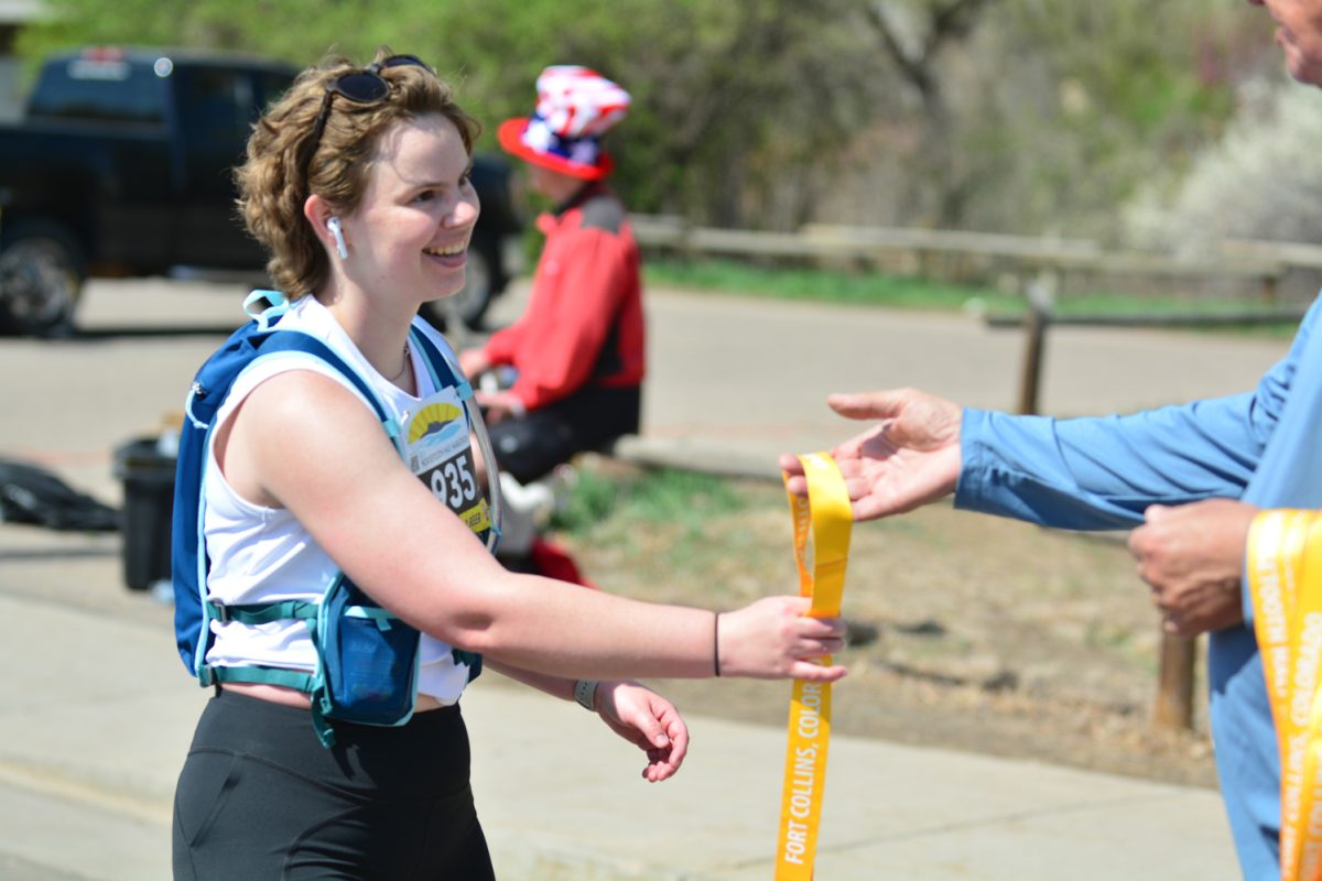 Makenna Juergans receiving her award after finishing the Horsetooth Half Marathon April 13. Makenna placed 1856 after running 13.1 miles. 