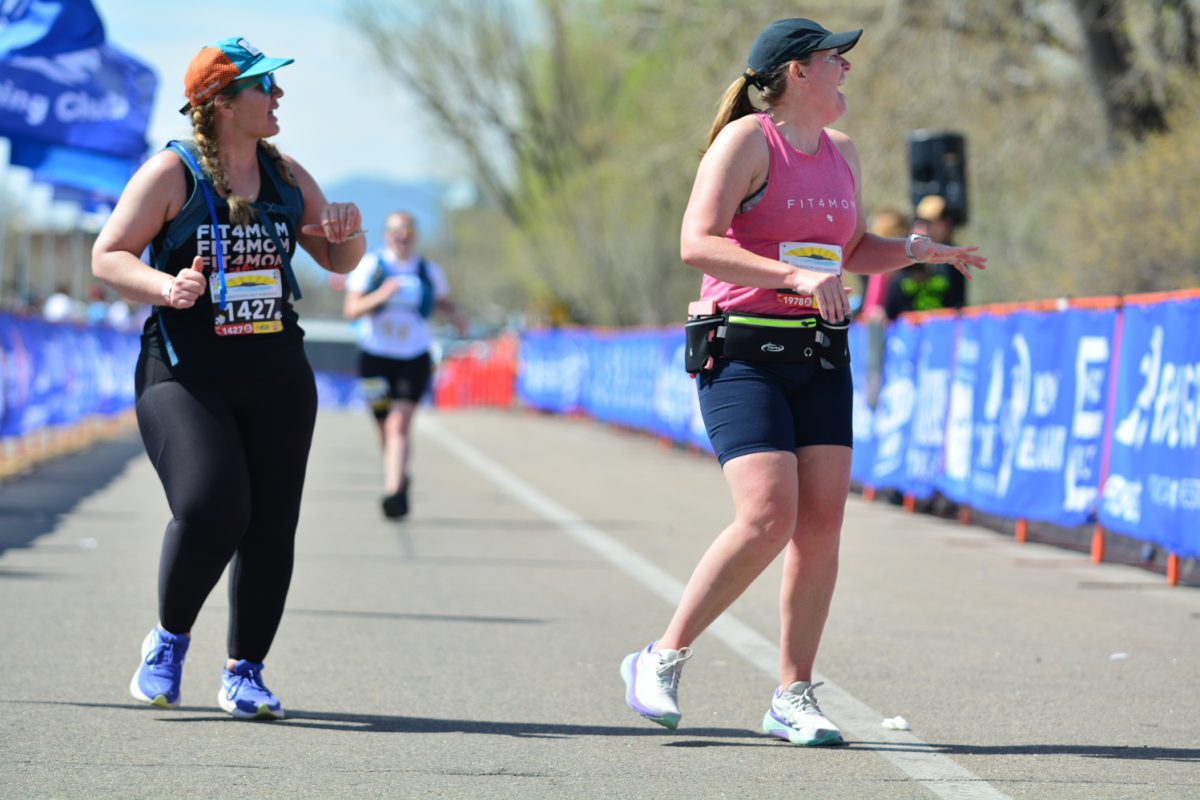 Kelsey Vogt and Alexandria Paisley laughing at the announcer as they finish the Horsetooth Half Marathon April 13. This Horsetooth Half Marathon is 13.1 miles that started at Horsetooth and finished at New Belgium. 
