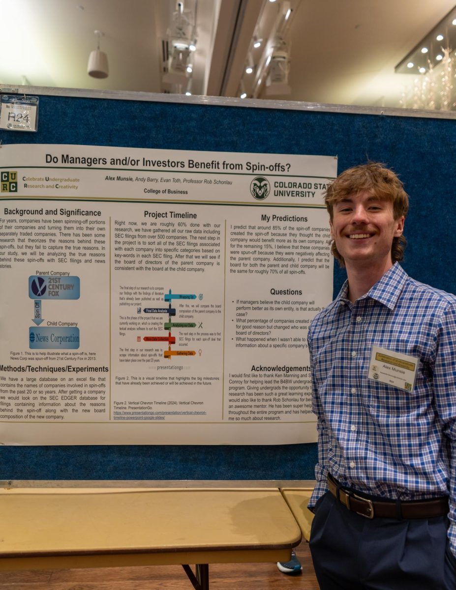Alex Munsie presents his research at the CURC Festival examining the reasons behind why large corporations make sperately traded "child companies." His exhibit and many others were on display at the Celebrate Undergraduate Research & Creativity Showcase in the Lory Student Center on April 17. 