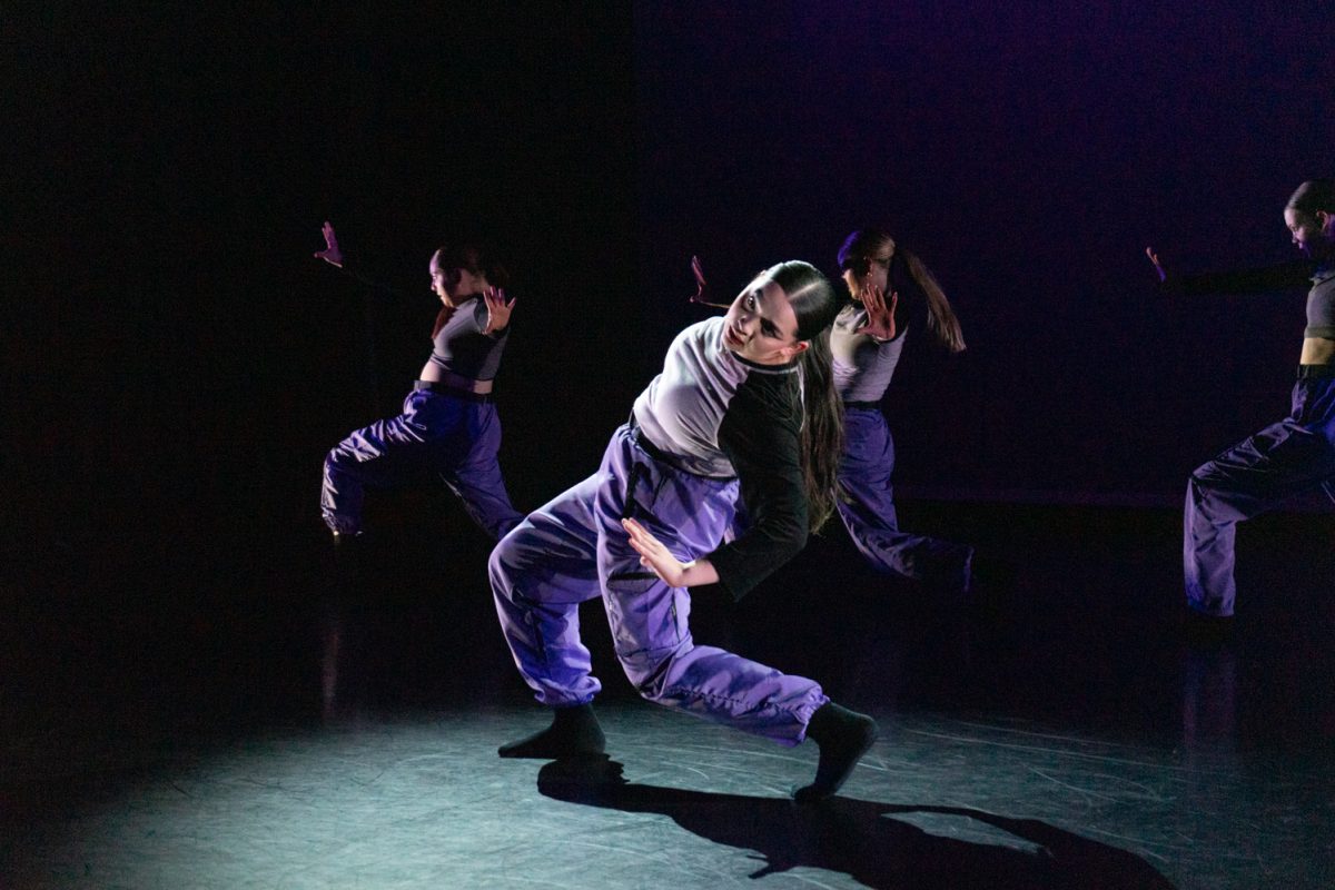 Student dancers, including Amethyst Aligaen, Alyssa Benik, Rylie Niemann, Kaitlyn Tayntor, and Jacqueline Urquidez, are spotlit while performing, “Muyé,” choreographed by Hannah Essig at Colorado State University’s Spring 2025 Dance Concert April 17.