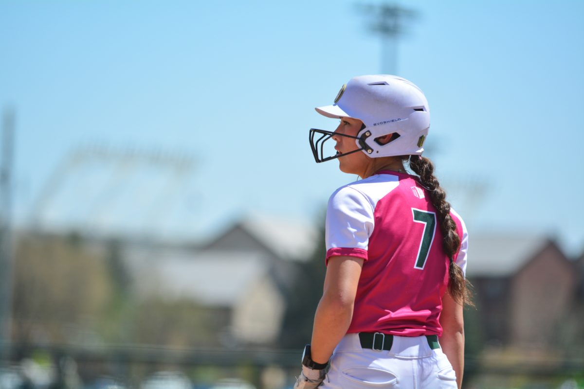 Autumn Rutherford watches the play after getting to first base during Colorado State University softball's double-header against was against Fresno State University.