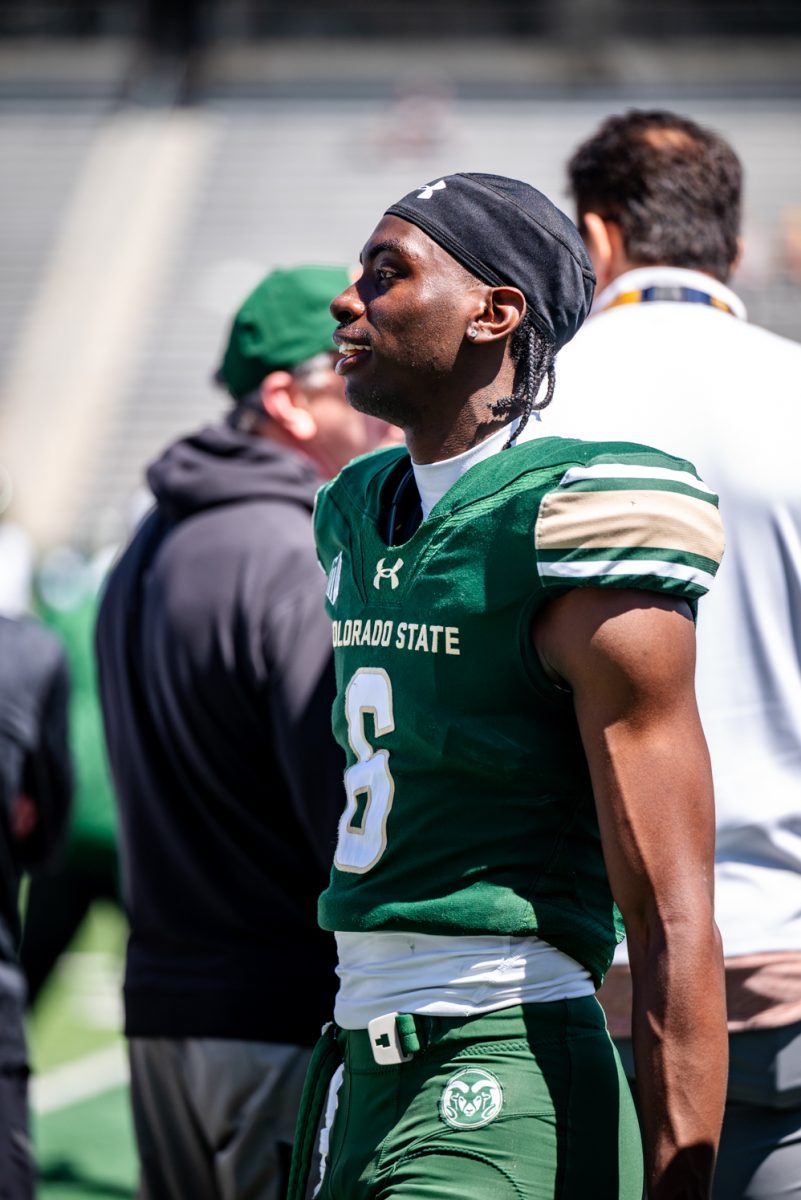 Wide reciever Tay Lanier (6) smiles at a teammate on the sidelines during a spring football scrimmage April 26.