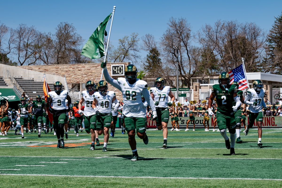 Colorado State University football players run onto the field to start a spring football scrimmage April 26.