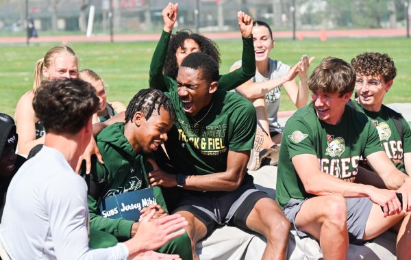 Travis Turner celebrates a win with his team during the Colorado State University versus Wyoming Border Dual April 26. Turner ran a 21.16 in the 200-meter dash.