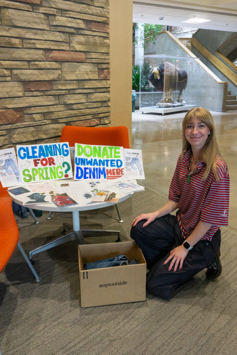 Neva Morgan, a Colorado State University junior studying Ecosystem Science and Sustainability, folds a denim jacket in the Natural Resources building April 29. Morgan is collecting denim for her mother, Megan Morgan, an artist who is "creating a sculpture from donated jeans, exploring transformation and sustainability," according to her collection flier. "We've had conversations about greenwashing, making sure what she's actually doing is sustainable and there's been an impact in some way," Neva said.