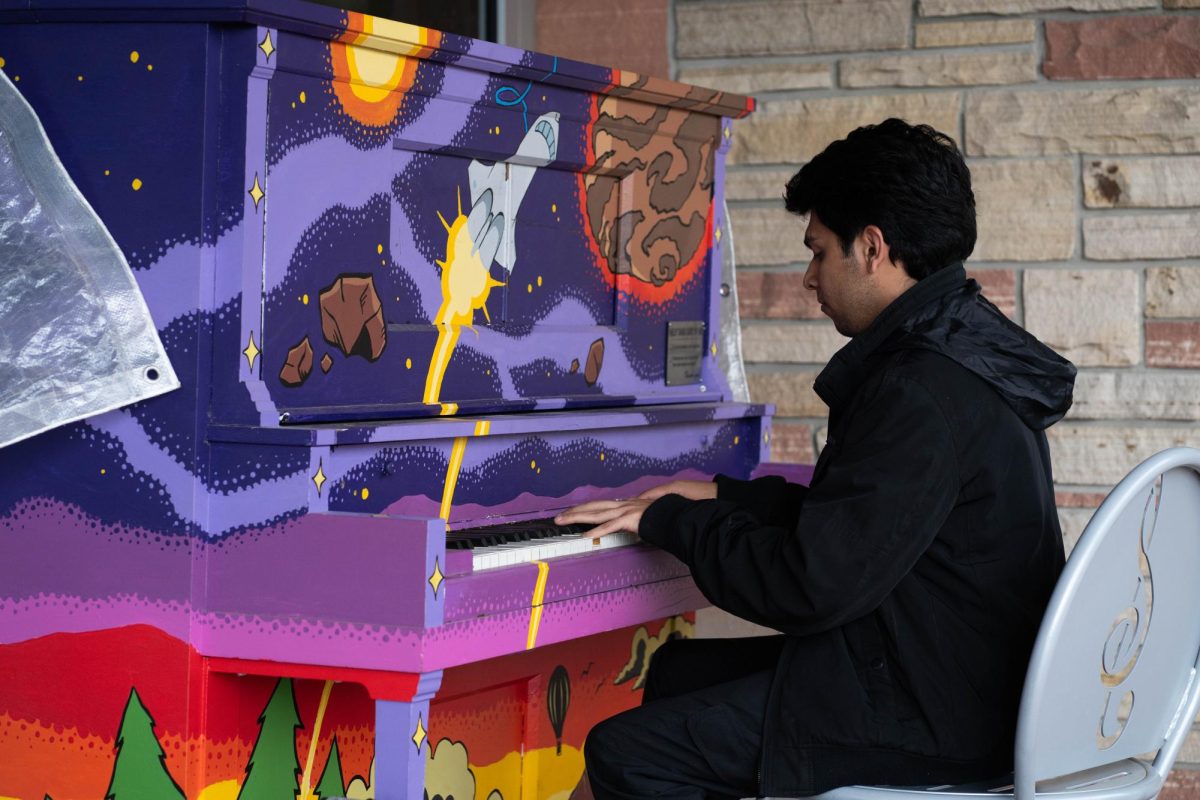 Pianist Saloj Abbas sits and plays an outdoor piano in front of the Lory Student Center April 28. Abbas has been playing piano for seven years and is self taught. 
