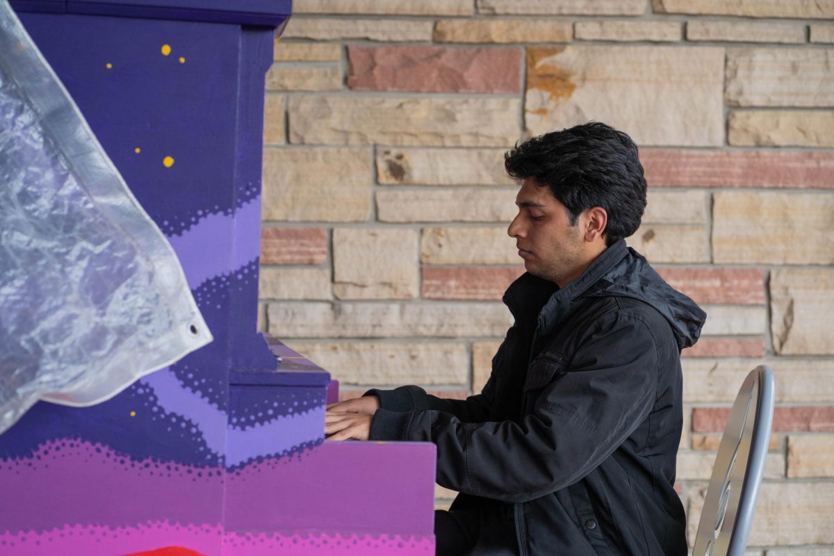 Pianist Saloj Abbas sits and plays an outdoor piano in front of the Lory Student Center April 28. Abbas played a rendition of "My Heart Will Go On."