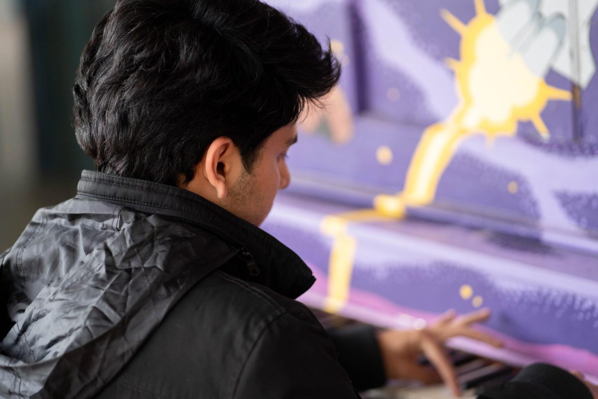 Pianist Saloj Abbas sits and plays an outdoor piano in front of the Lory Student Center April 28. Abbas played a rendition of "My Heart Will Go On."