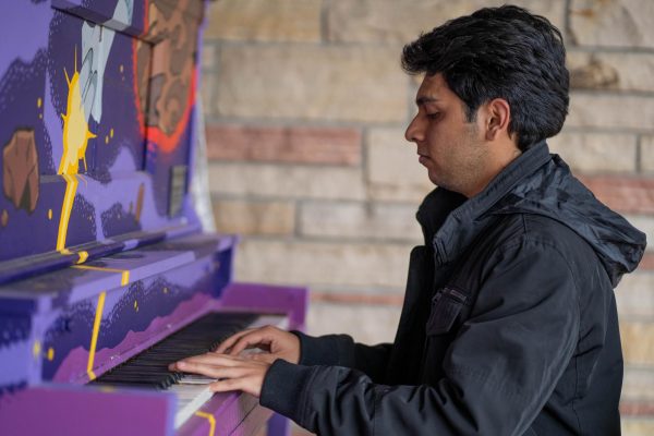 Image of a person playing a piano.