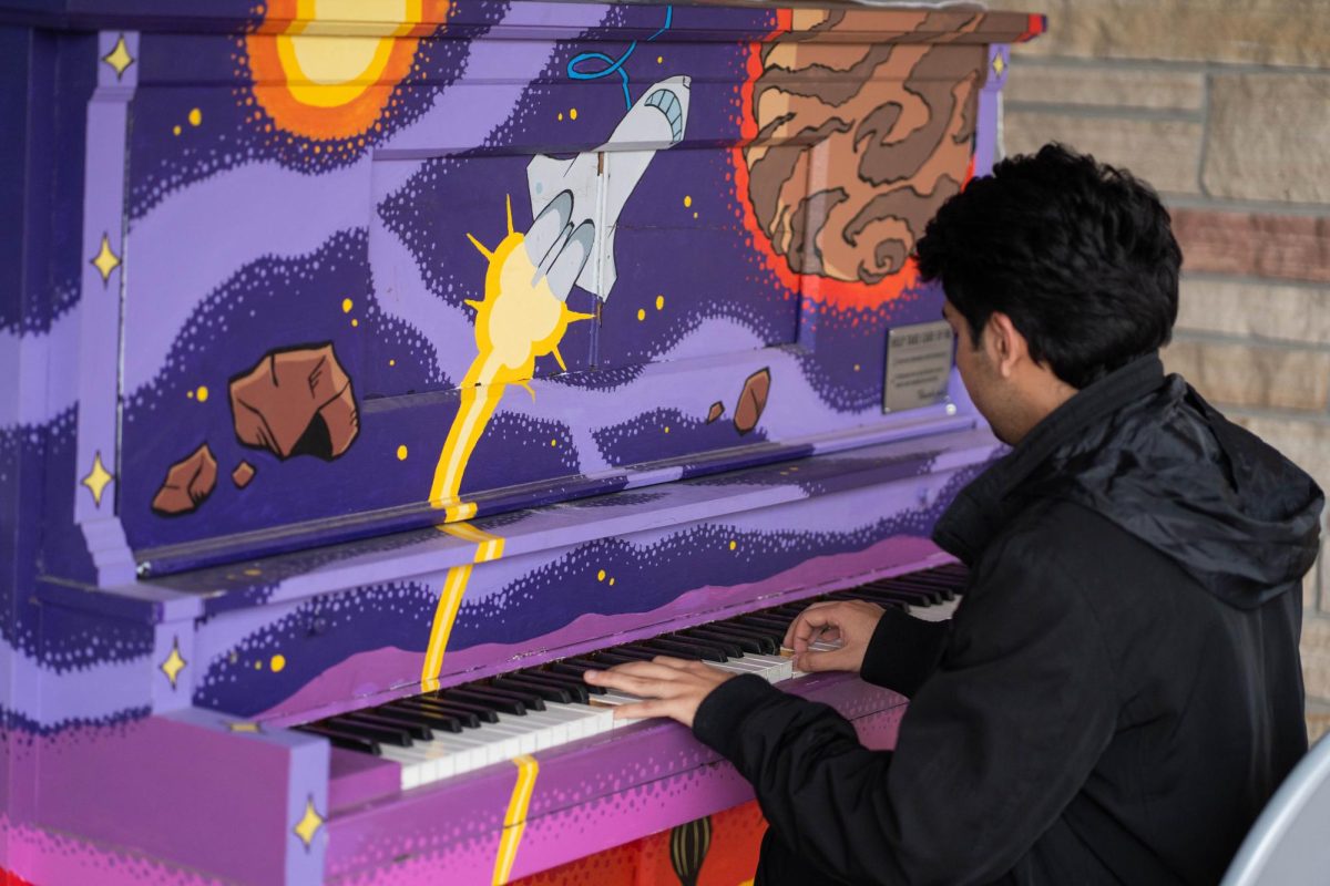 Pianist Saloj Abbas sits and plays an outdoor piano in front of the Lory Student Center April 28. Abbas played a rendition of "My Heart Will Go On."