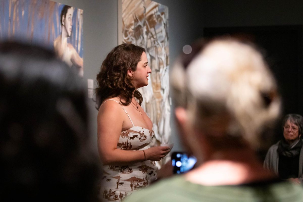 Claudia Bokulich talks about her paintings during her graduate showcase artist talk at the Gregory Allicar Museum of Art in the University Center for the Arts at Colorado State University April 24. "I'm looking for materials that demonstrate cultural construction of femininity and gender in America and also consumerism and vanity," Bokulich said.