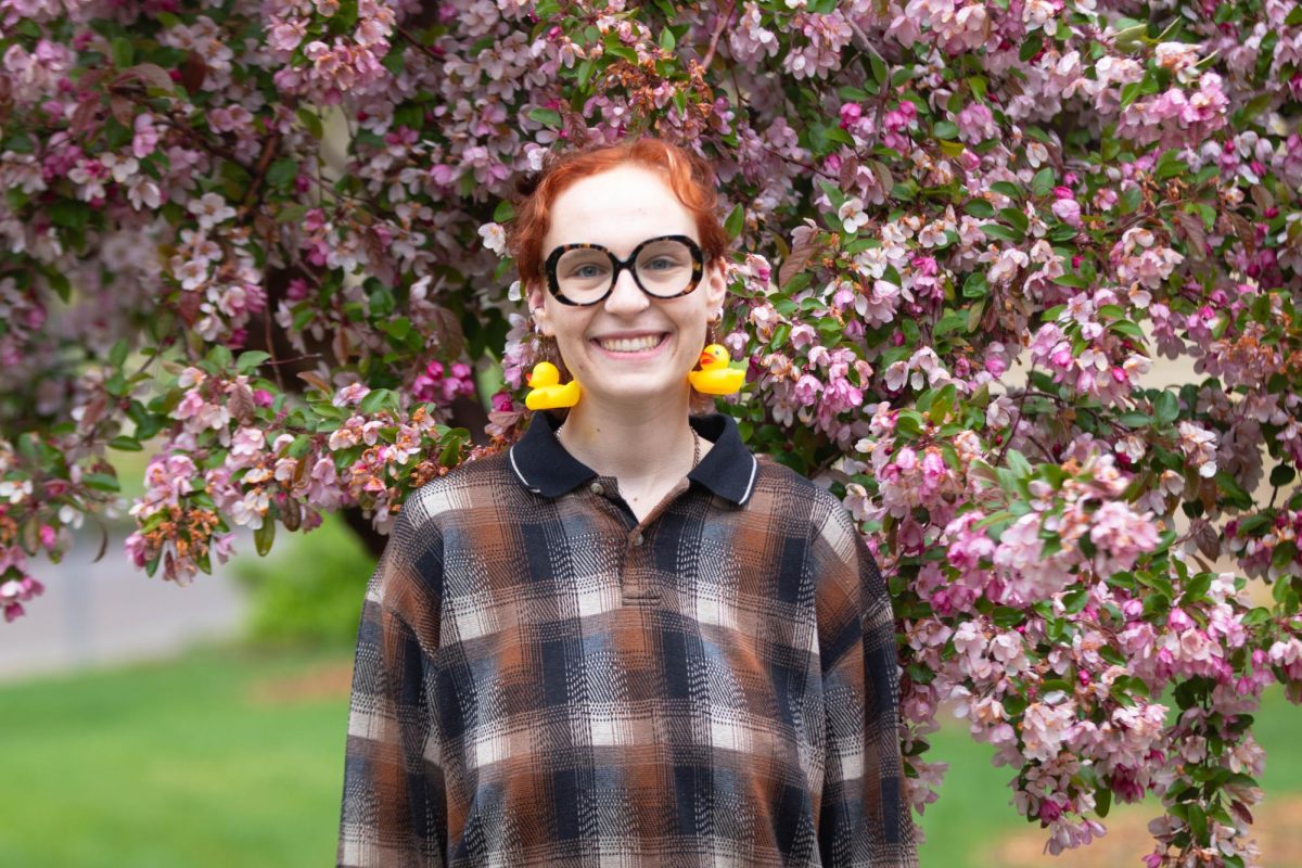 Image of a person standing in front of a blooming tree.