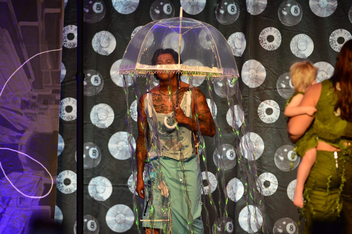 Senior Karina Usuda dresses model during the Astral Thread Fashion show April 3. This was at the Lory Student Center Ballroom. 