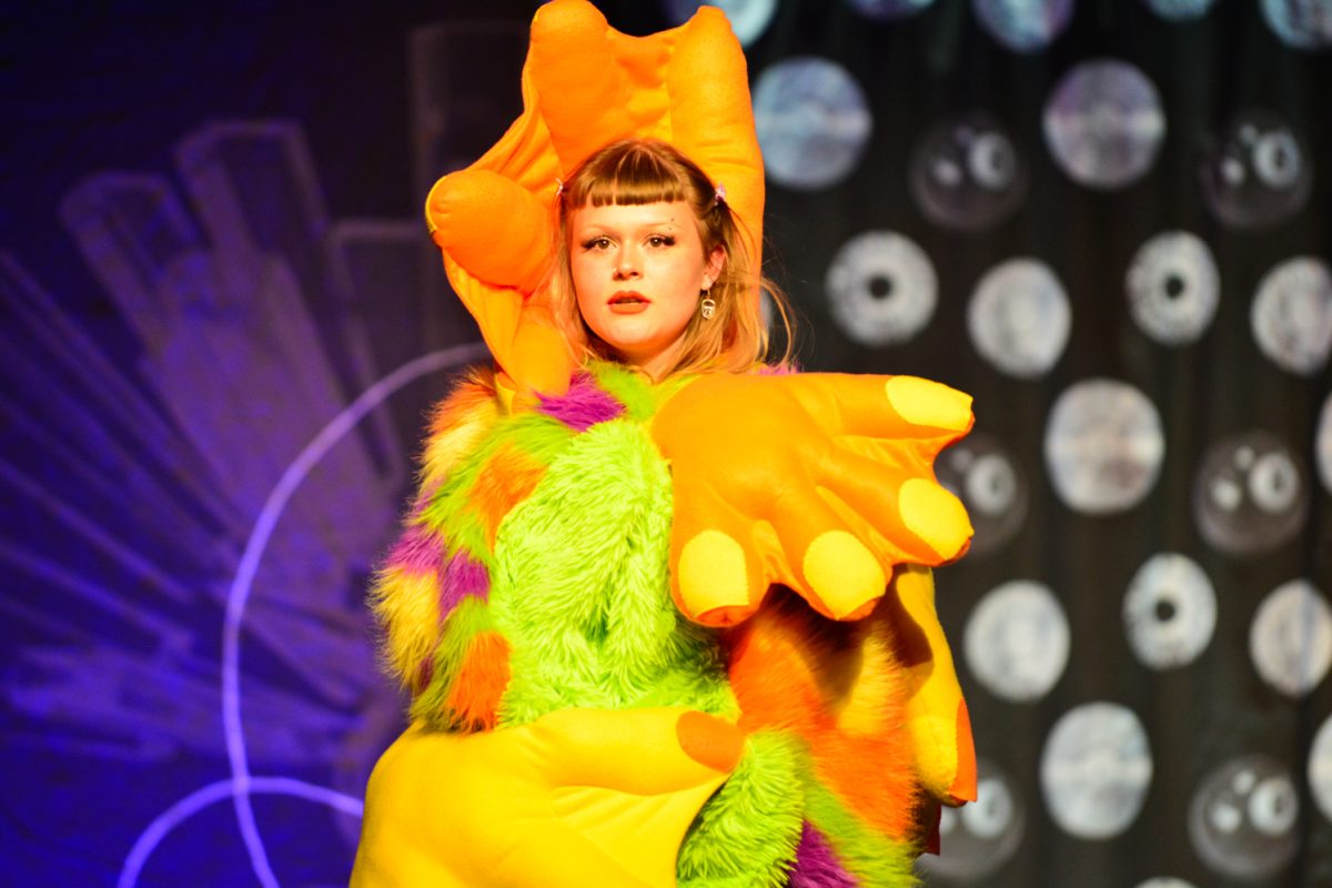 A colorful design created by senior Nathalia Olvera-Barajas is worn by a model May 3. The Astral Threads Fashion Show was put on in the Lory Student Center Grand Ballroom. 