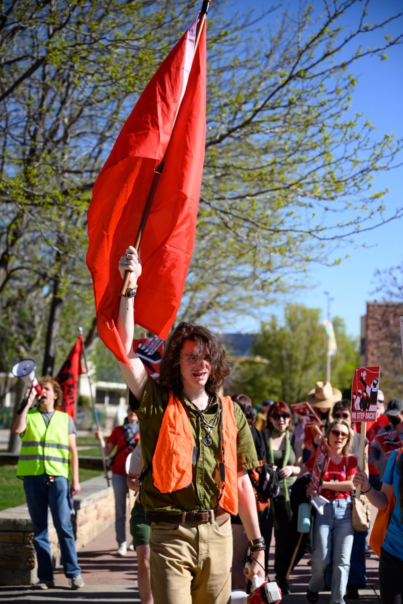 Jonas Andersen, co-chair of Colorado State University's chapter of the Young Democratic Socialists of America, helps lead the "March for Workers' Rights" protest out of the Lory Student Center Plaza May 2.