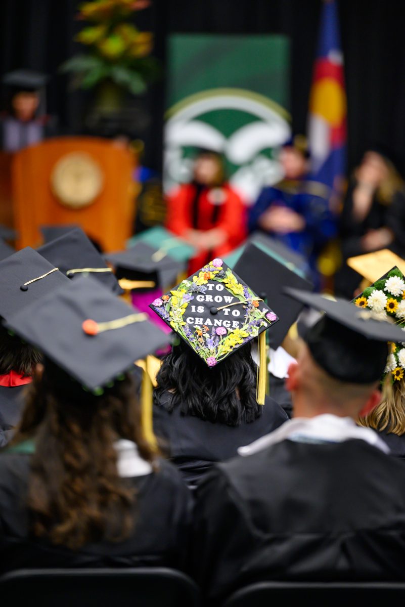 A student with a grad cap that reads, "To grow is to change" listens to speakers at the Agricultural Biology, Horticulture and Landscape Architecture and Soil and Crop Sciences recognition ceremony May 18.