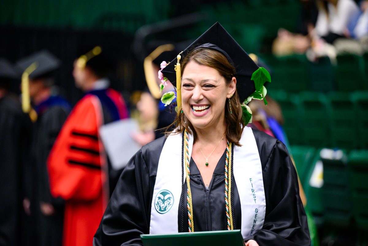A first-generation graduating student smiles as she walks off the stage with her diploma during the Agricultural Biology, Horticulture and Landscape Architecture and Soil and Crop Sciences recognition ceremony in Moby Arena May 18.
