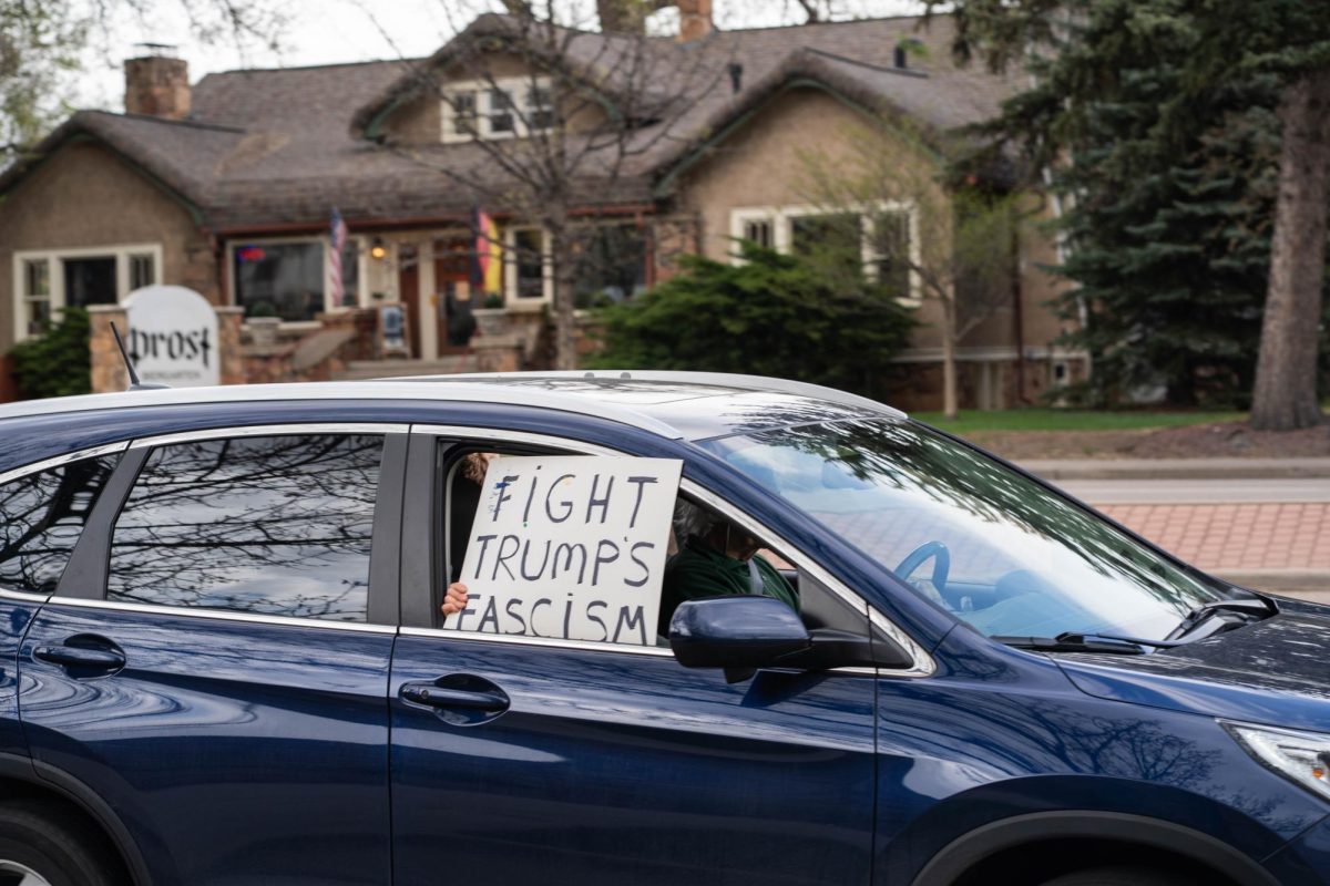 A passing car takes place in the May Day protests May 1 on College Ave.  Part of the May Day protests, a nation-wide movement protesting recent federal actions, Fort Collins residents lined College Ave.  