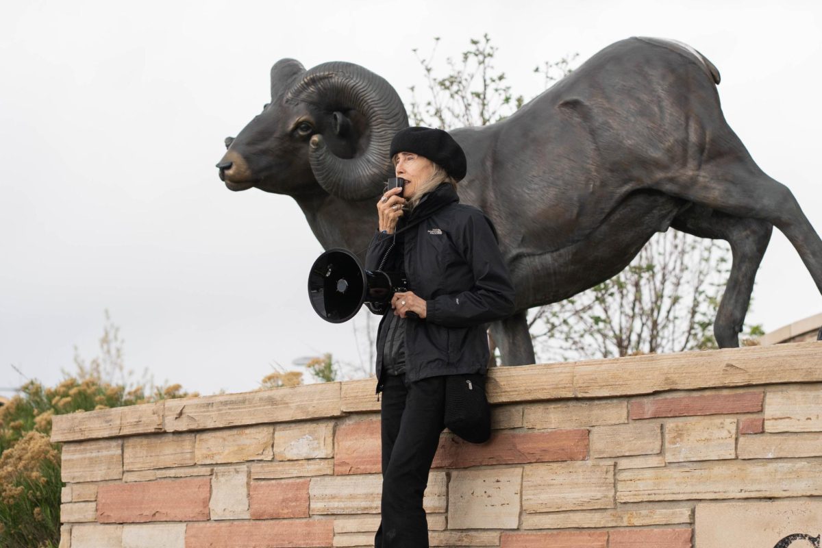 A chant organizer for the May Day protests chants into a loud speaker by the Colorado State University Health Network.  Part of the May Day protests, a nation-wide movement protesting recent federal actions, Fort Collins residents lined College Ave.  