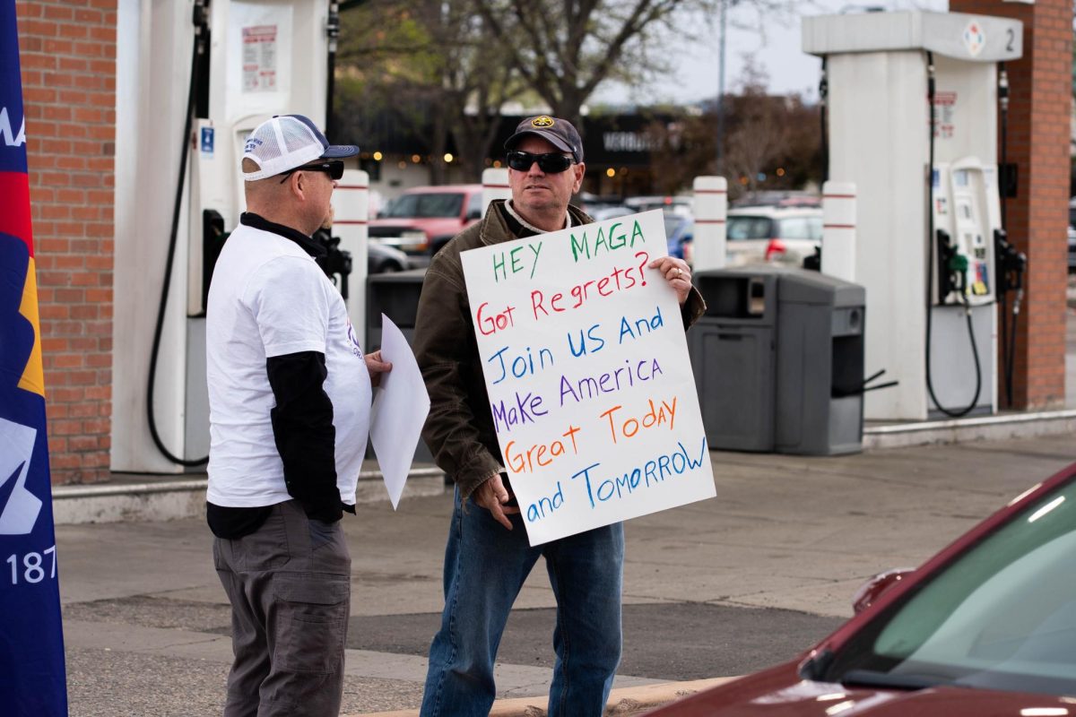 Protestor George Grossnan holds a sign outside of the Conoco-Phillips gas station on Prospect road. Part of the May Day protests, a nation-wide movement protesting recent federal actions, Fort Collins residents lined College Ave.  