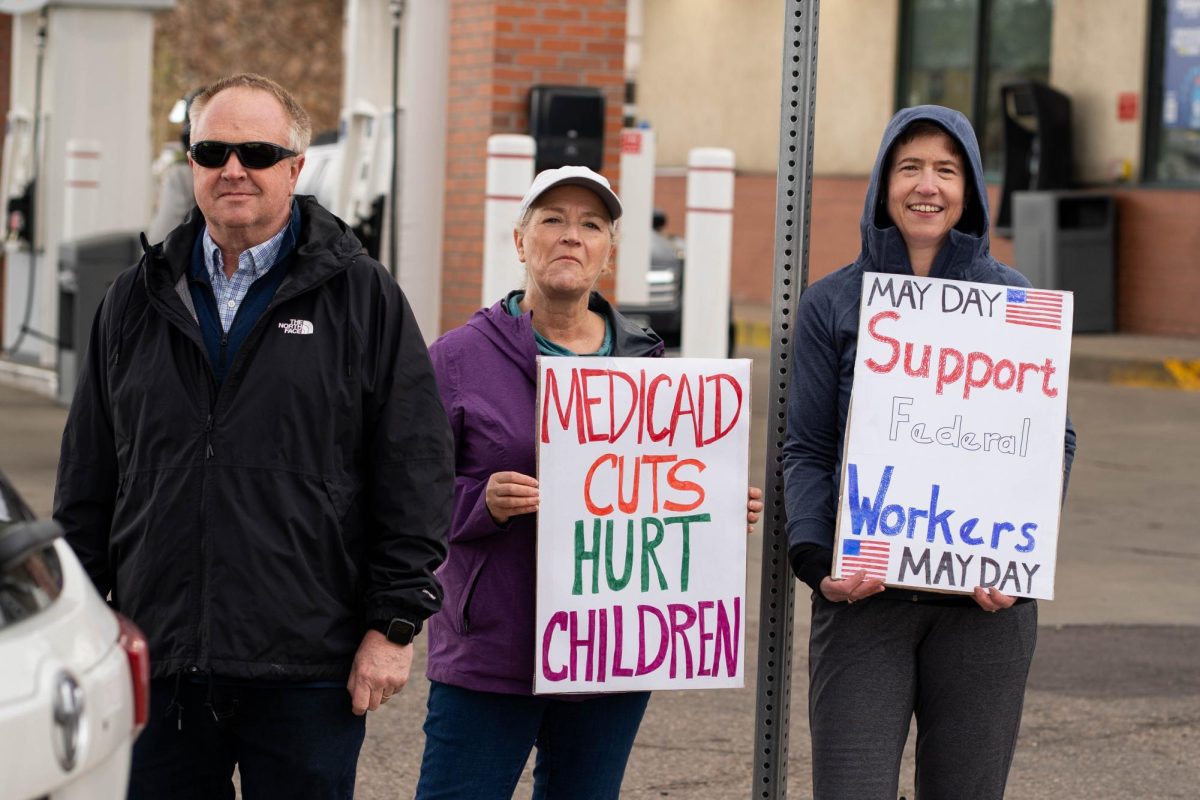 Tracey Brady, Rebecca Orsi-Hunt and fellow protestors stand outside the Conoco Philips gas station on Prospect road.  Part of the May Day protests, a nation-wide movement protesting recent federal actions, Fort Collins residents lined College Ave.  

