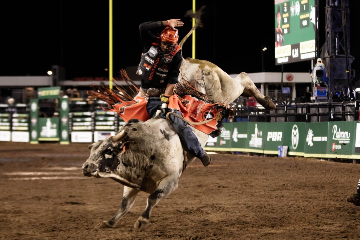 Pro bull rider Sandro Batista fights to stay on the bull during his ride at PBR's The Last Cowboy Standing event in Fort Collins Colorado at Canvas Stadium at Colorado State University on July 22, 2025. Photo taken by Erica Pickering.