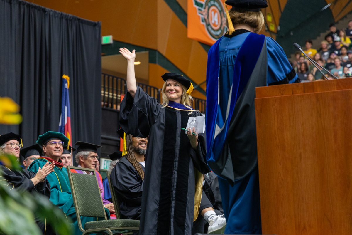Colorado State University President Amy Parsons waves at students attending Convocation in Moby Arena Aug. 24.