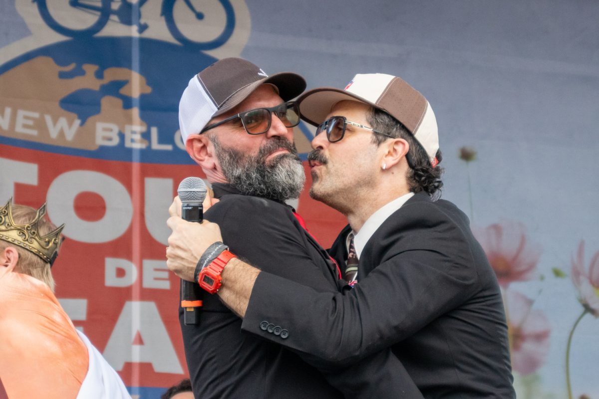 Two emcees at Tour de Fat share a display of affection during the dance competition Aug. 23.