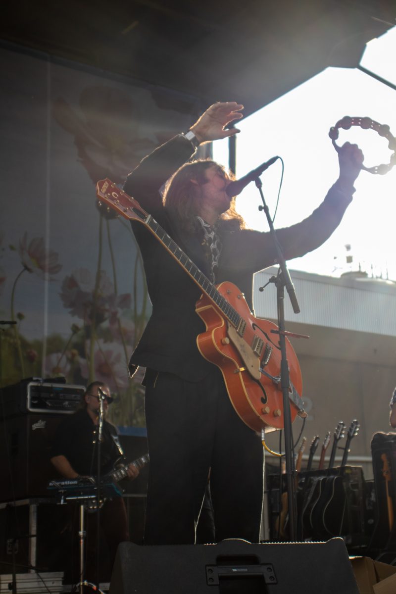 Adam Turla, lead vocalist for Murder By Death, sings and shakes a tambourine during the band's performance at Tour de Fat Aug. 23.